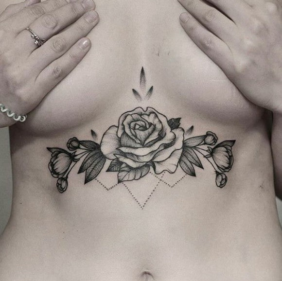 Blackwork floral sternum tattoo
