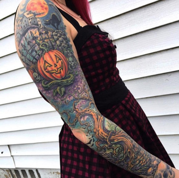 Halloween-themed sleeve tattoo by Norm Wright Jr