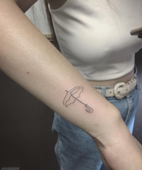 Minimalistic umbrella tattoo by Alison Nie