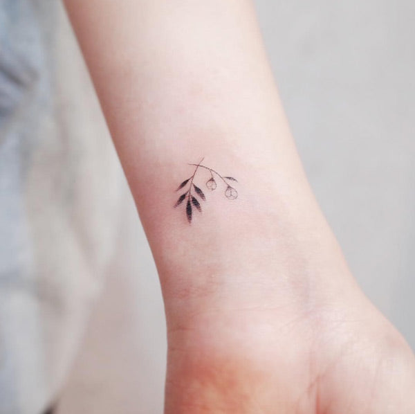 Small floral wrist tattoos by Witty Button