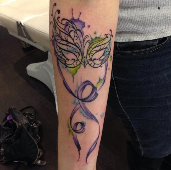 Watercolor venetian mask tattoo by Kylie Gibson